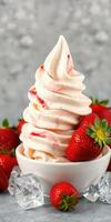 Delicious swirling strawberry soft serve ice cream topped with fresh strawberries and ice cubes photo