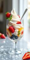 Delicious dessert featuring soft serve, fresh fruits, and whipped cream served in a glass bowl photo