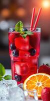 Refreshing summer beverage with berries and citrus served in a tall glass photo