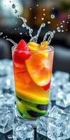 Colorful fruit cocktail splashes in a glass filled with ice cubes captured in a stylish setting photo