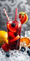 Refreshing fruit punch served in a tall glass with vibrant berries and citrus slices on a chilled surface photo