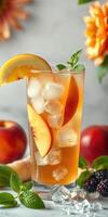 Refreshing peach iced tea with fresh fruit and mint on a sunny kitchen counter photo