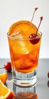 Refreshing cocktail with orange slice and cherry served in a glass with ice photo