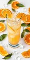 Refreshing orange drink with ice and vibrant orange slices on a white surface photo