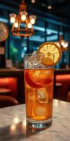 Refreshing iced tea with citrus slices served in a cozy cafe setting during evening hours photo