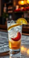 Refreshing summer cocktail with ice and fruit served in a glass at a modern bar photo
