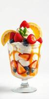 Fresh fruit parfait served in a clear glass topped with whipped cream and mint leaves photo