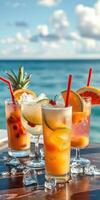 Colorful tropical cocktails served on beachside table during sunny day by the ocean photo
