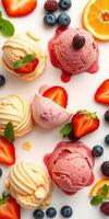 Delicious ice cream scoops on a white background decorated with fresh fruit and mint leaves in a colorful arrangement photo