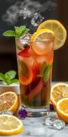 Refreshing summer mocktail with citrus fruits and mint served in a tall glass photo