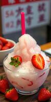 Refreshing strawberry snow dessert topped with fresh fruit in a vibrant bowl at a dessert shop photo
