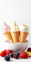Three colorful ice cream cones in a bowl surrounded by fresh fruits on a white background photo