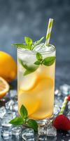 Refreshing summer drink with lemon and mint garnished with berries and ice photo