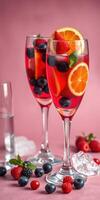 Refreshing summer fruit drinks served in elegant glasses with a vibrant pink background photo