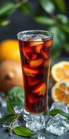 Refreshing iced tea with fresh fruit and herbs in a glass, beautifully arranged with citrus and greenery backdrop photo