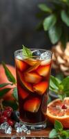 Refreshing iced beverage with fruits and herbs on a wooden surface in a cozy setting photo