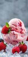Delicious raspberry ice cream served in a clear bowl with fresh berries and mint leaf on a bed of ice photo