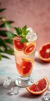 Refreshing citrus drink with grapefruit and mint on a marble surface photo