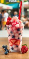Refreshing dessert featuring mixed fruits and colorful toppings enjoyed at an outdoor cafe during a sunny day photo
