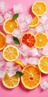 Vibrant citrus slices with ice cubes create a refreshing summer vibe on a pink background photo