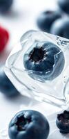 Fresh blueberries trapped in ice cube with a blurred background of berries creating a cool and refreshing atmosphere photo