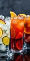 Refreshing summer cocktails with citrus fruits and ice served in tall glasses photo
