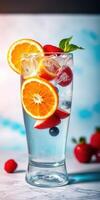 Refreshing summer drink with fruit garnishes served in a tall glass with ice and colorful accents photo