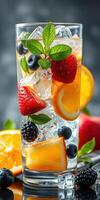 Refreshing summer drink with vibrant fruits and ice in a tall glass by a dark background photo