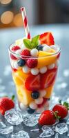 Refreshing fruit salad delight with vibrant colors served in a clear glass on a table photo