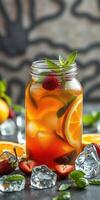 Refreshing iced tea with fruits and mint served in a mason jar on a table photo