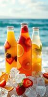 Refreshing fruit drinks in clear bottles beside the ocean on a sunny day photo