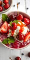 Delicious dessert featuring cherries, strawberries, and whipped cream in a vibrant, colorful bowl photo