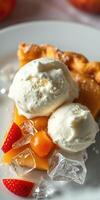 Delicious slice of apple pie topped with creamy ice cream and fresh fruit served on a white plate photo