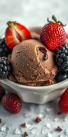Delicious chocolate ice cream topped with fresh strawberries and blackberries in a white bowl photo