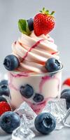 Delicious dessert featuring layered frozen yogurt topped with berries and syrup in a decorative cup photo