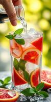 Refreshing summer beverage preparation with vibrant fruits and herbs outdoors photo