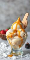 Delicious vanilla ice cream with caramel drizzle served in a clear bowl with fresh strawberries and blackberries on a marble surface photo