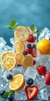 Refreshing summer drink with lemons and mixed berries on ice in a bright setting photo