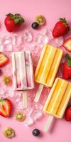 Colorful frozen popsicles surrounded by fresh fruit and ice on a pink background photo