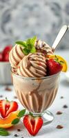Delicious chocolate ice cream topped with fresh strawberries and mint leaves served in a glass bowl photo