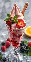 Delicious strawberry and raspberry soft serve topped with fresh fruit and mint in a glass dish photo