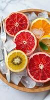 Freshly sliced citrus fruits arranged on ice for a vibrant summer refreshment on a sunny day photo