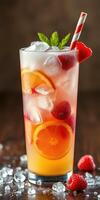 Refreshing summer drink with citrus and berries served in a tall glass filled with ice photo