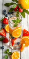 Refreshing fruit-infused drink with citrus and berries arranged on wooden surface photo
