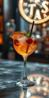 Colorful cocktail served in a glass with ice and garnished with fruit at a bar in the evening photo
