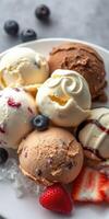 Delicious assortment of ice cream scoops with fresh berries served on a plate photo
