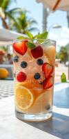 Refreshing summer cocktail with fresh fruits in a vibrant outdoor setting photo