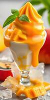 Delicious mango soft serve dessert topped with fresh mango chunks and mint leaves photo