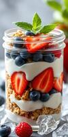 Healthy berry parfait layered with yogurt, granola, and fresh fruits in a jar photo
