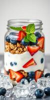 Delicious and healthy yogurt parfait with granola and fresh berries served in a clear jar photo